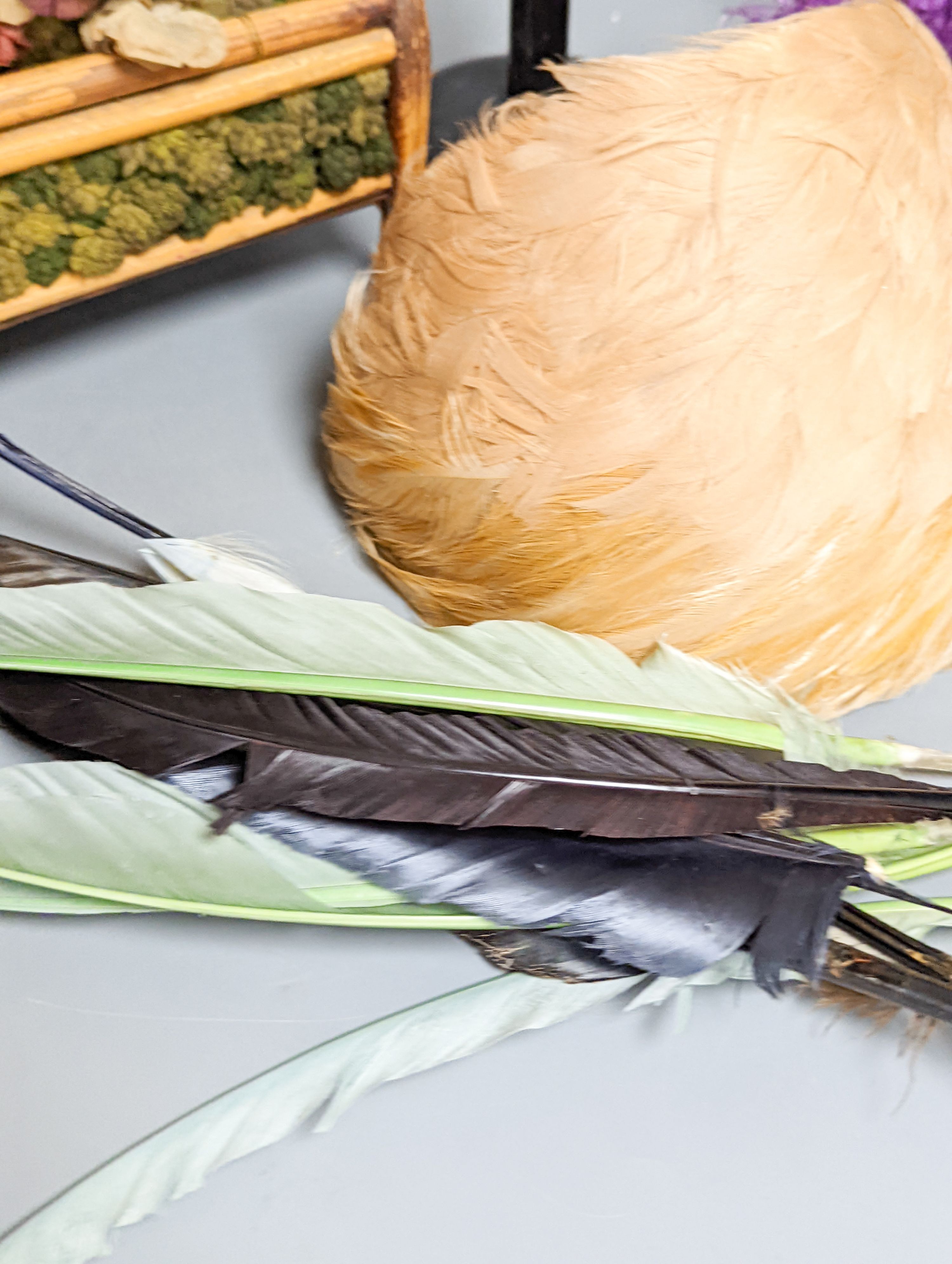 Two 1950's feather hats, another hat, 19th century bamboo sewing bag, collection of jet beading, feathers, ribbons, etc.